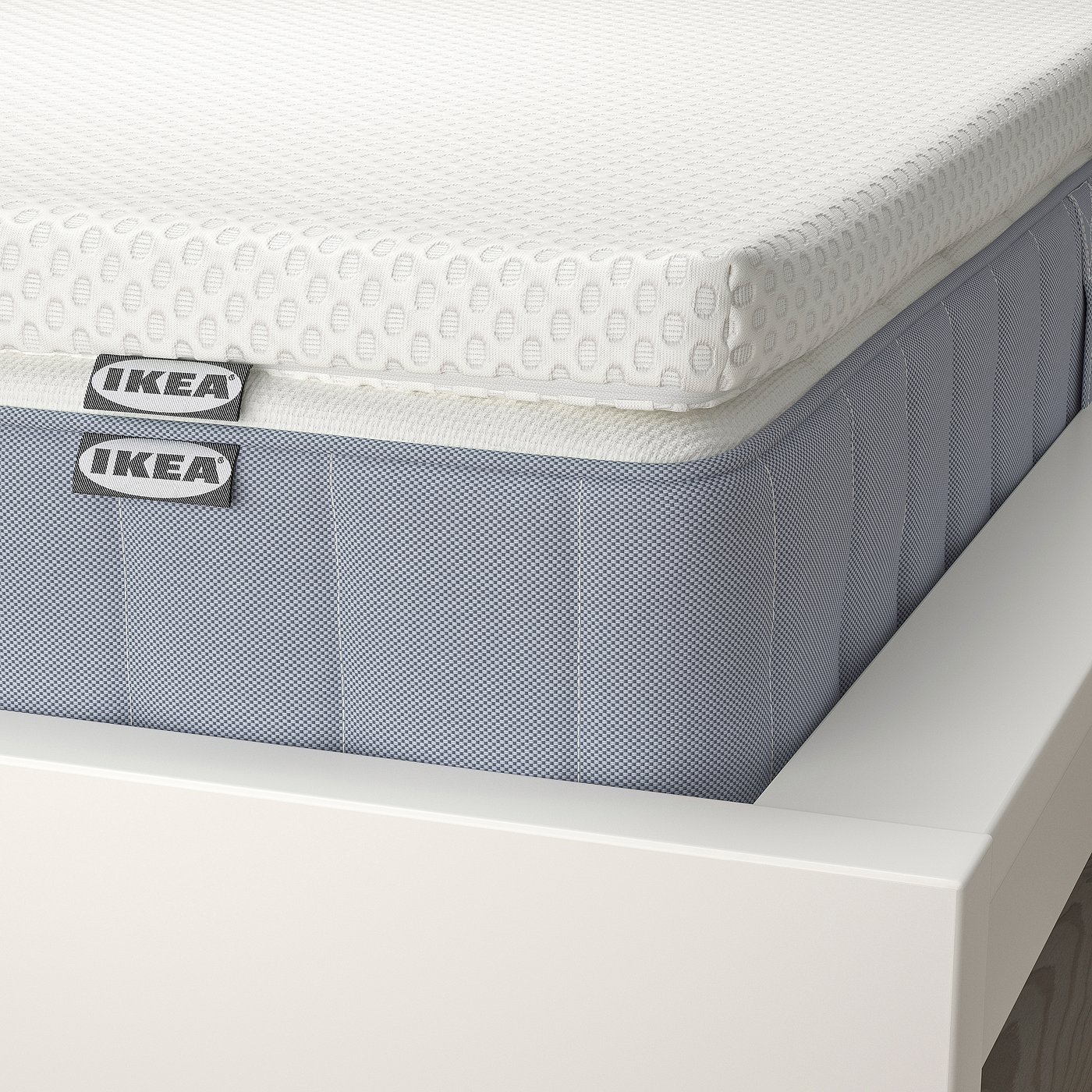 Close-up of IKEA mattress on bed, showing quality design with edge-to-edge support and breathable fabric.
