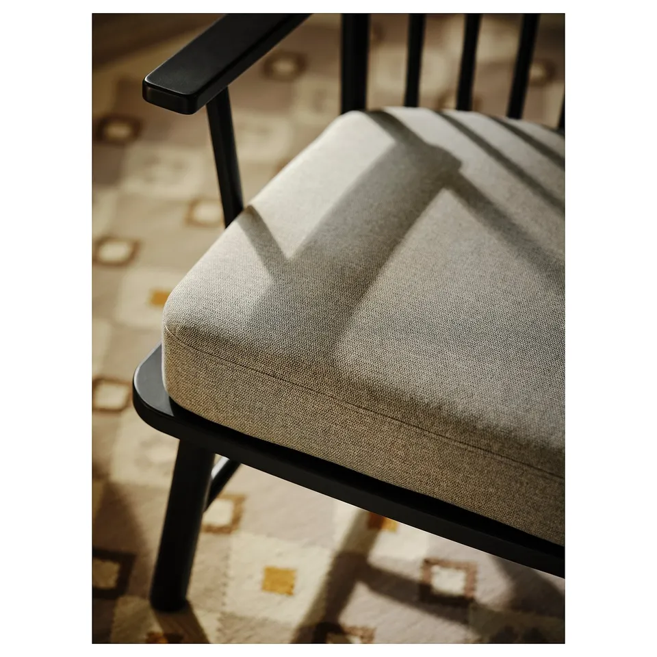 PERSBOL spindle armchair in beige fabric with dark wood frame.