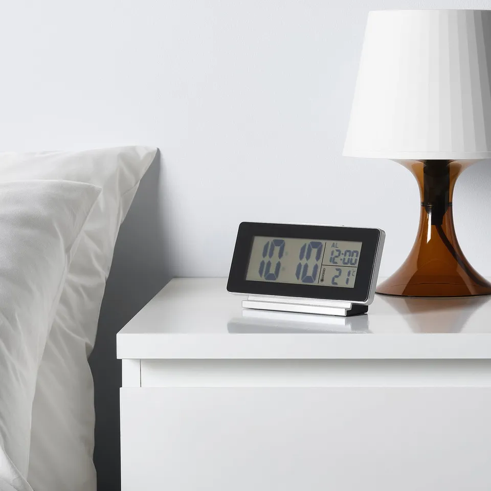Bedside alarm clock showing time 17:17, temperature 17. 1°c. Modern design with led display and white lamp.
