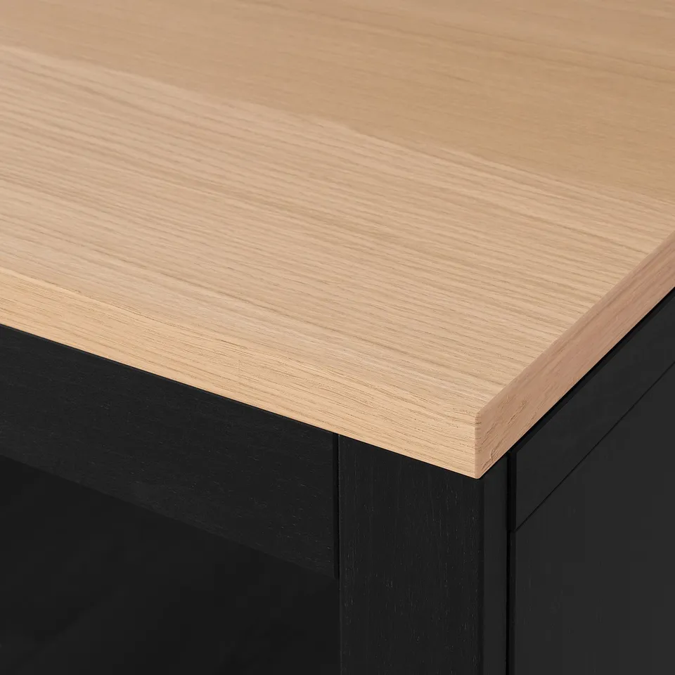 A sleek, wooden tabletop with a smooth, natural finish and slight grain texture, supported by sturdy, black legs.
