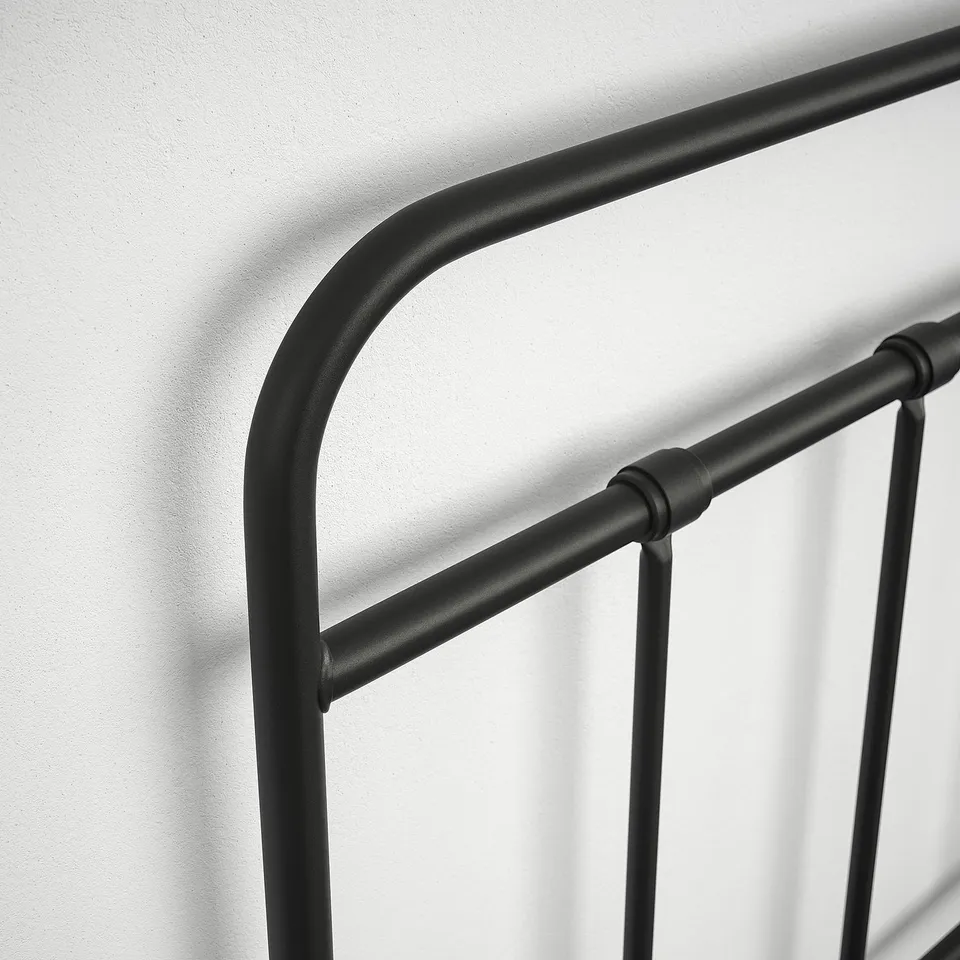 Black metal bed frame with curved headboard, featuring sleek design and sturdy construction.
