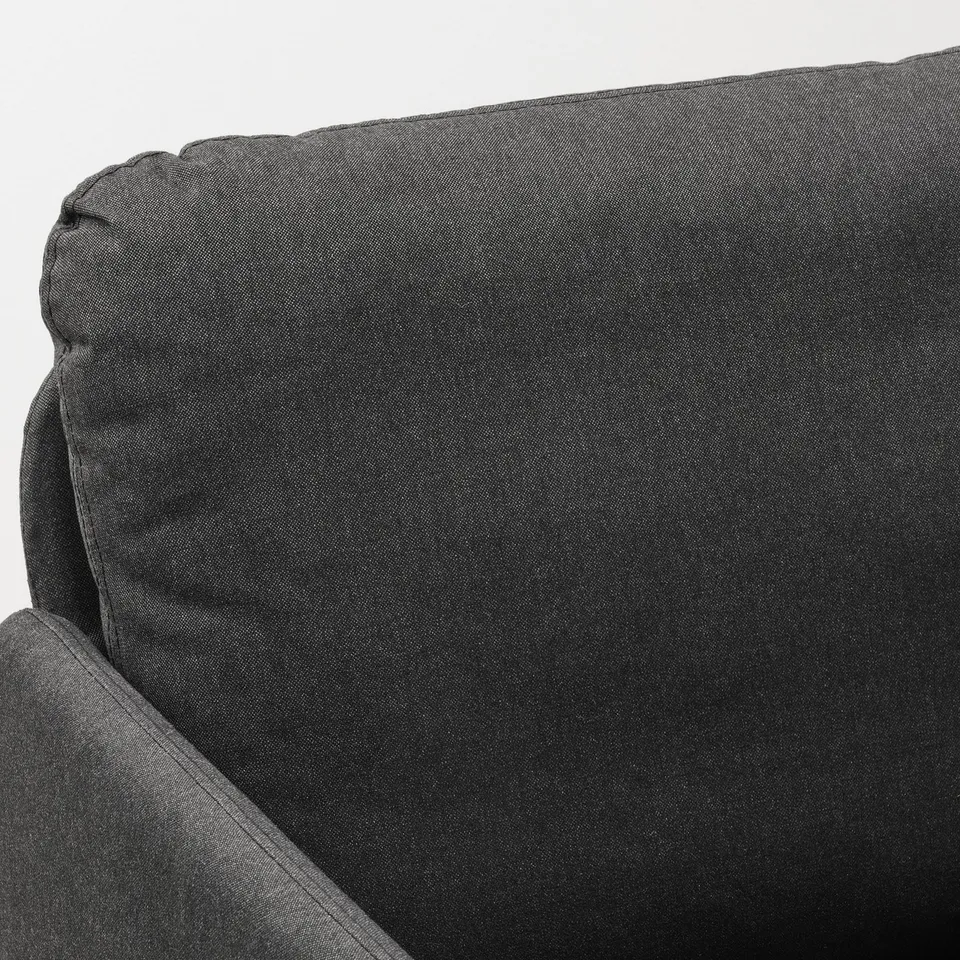 Close-up of GLOSTAD sofas armrest, showcasing its quality, soft polyester fabric and clean, modern design.