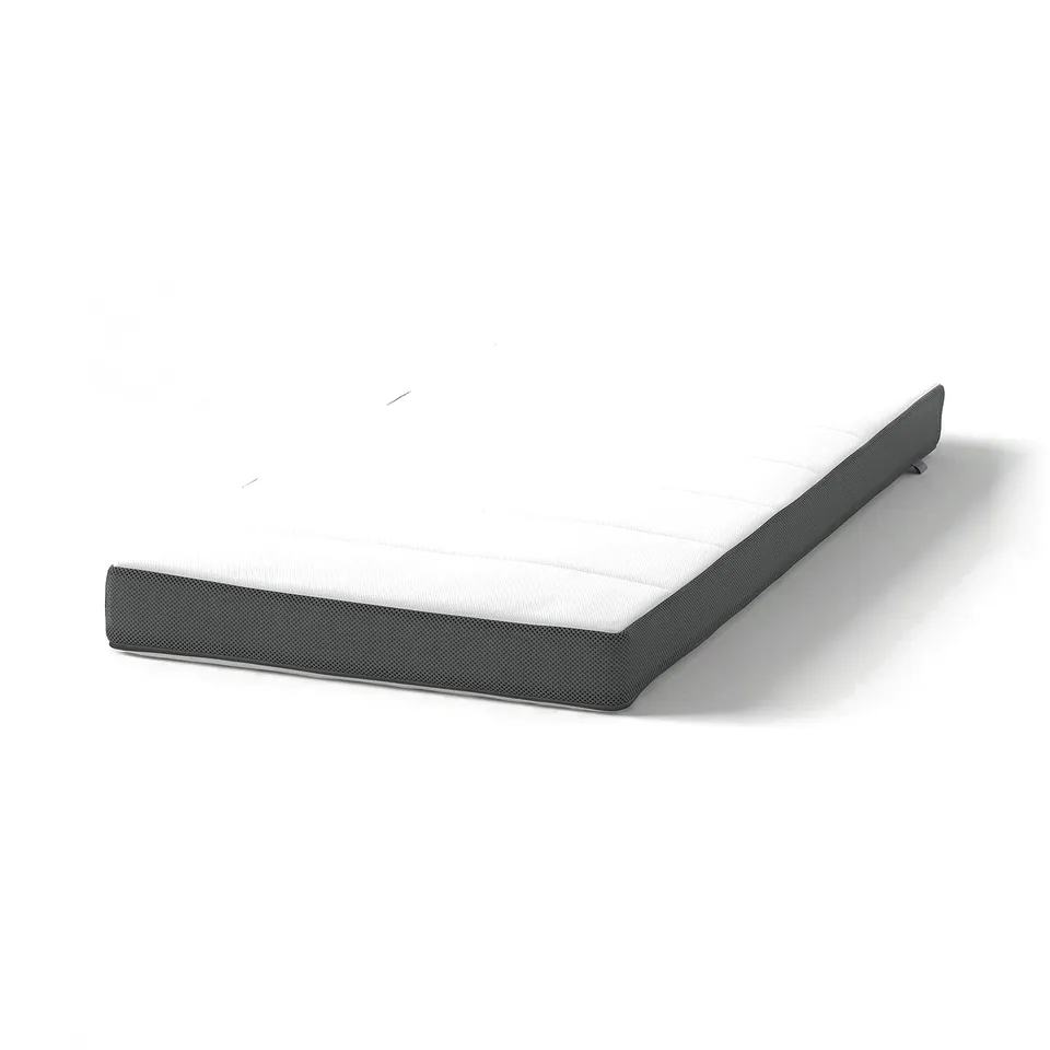 A DRÖMMANDE baby mattress in grey with a white centre, featuring a textured surface and rounded corners.