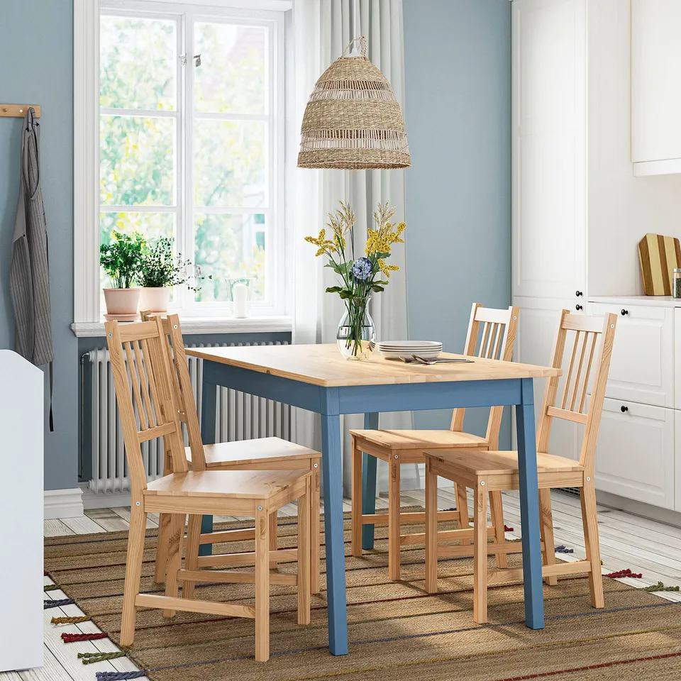 Cosy kitchen with PINNTORP chair & table. Vertical slat back chair by window with plant.