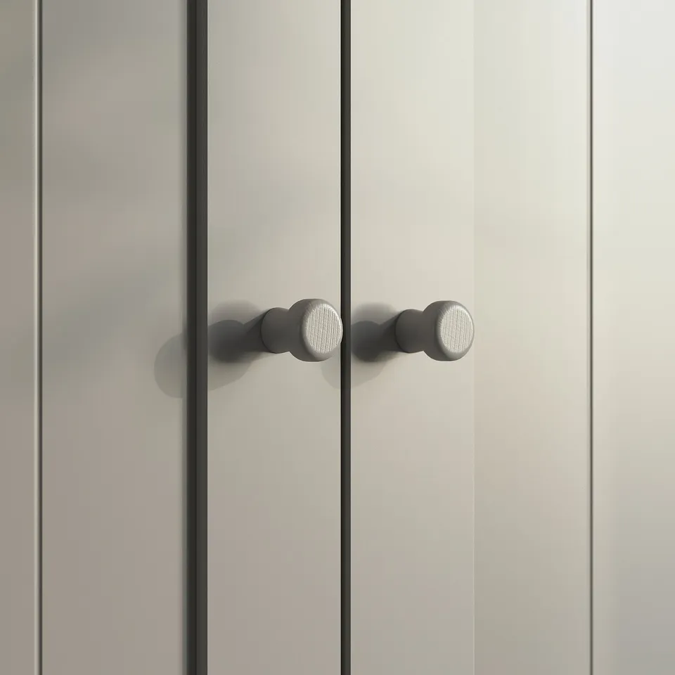 Grey wardrobe door with round knobs, modern design.