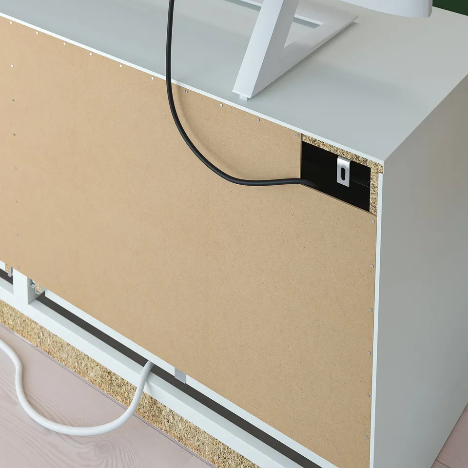 Cable management in tv unit, back panel with outlet and cord routing.