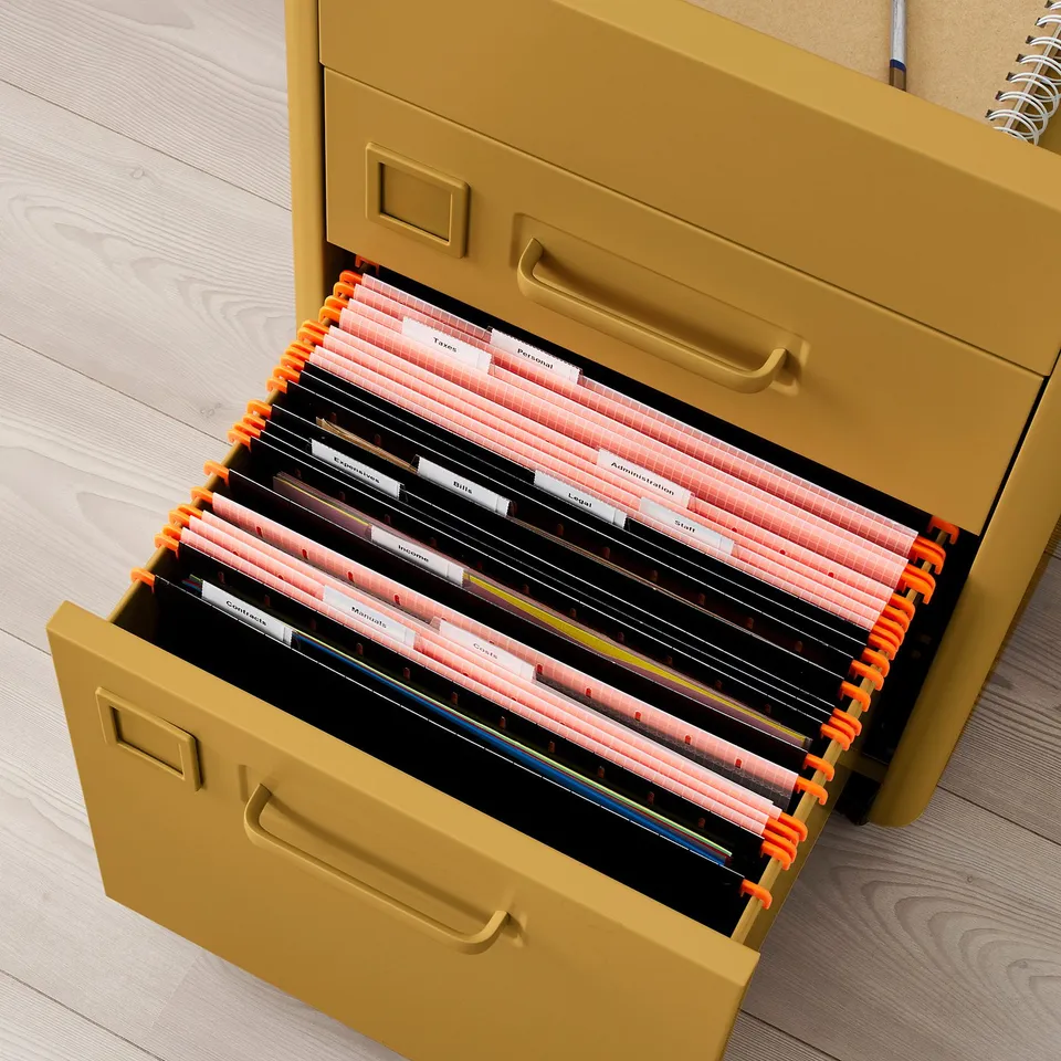 Open yellow filing cabinet with orange tabs, organised with labelled folders.
