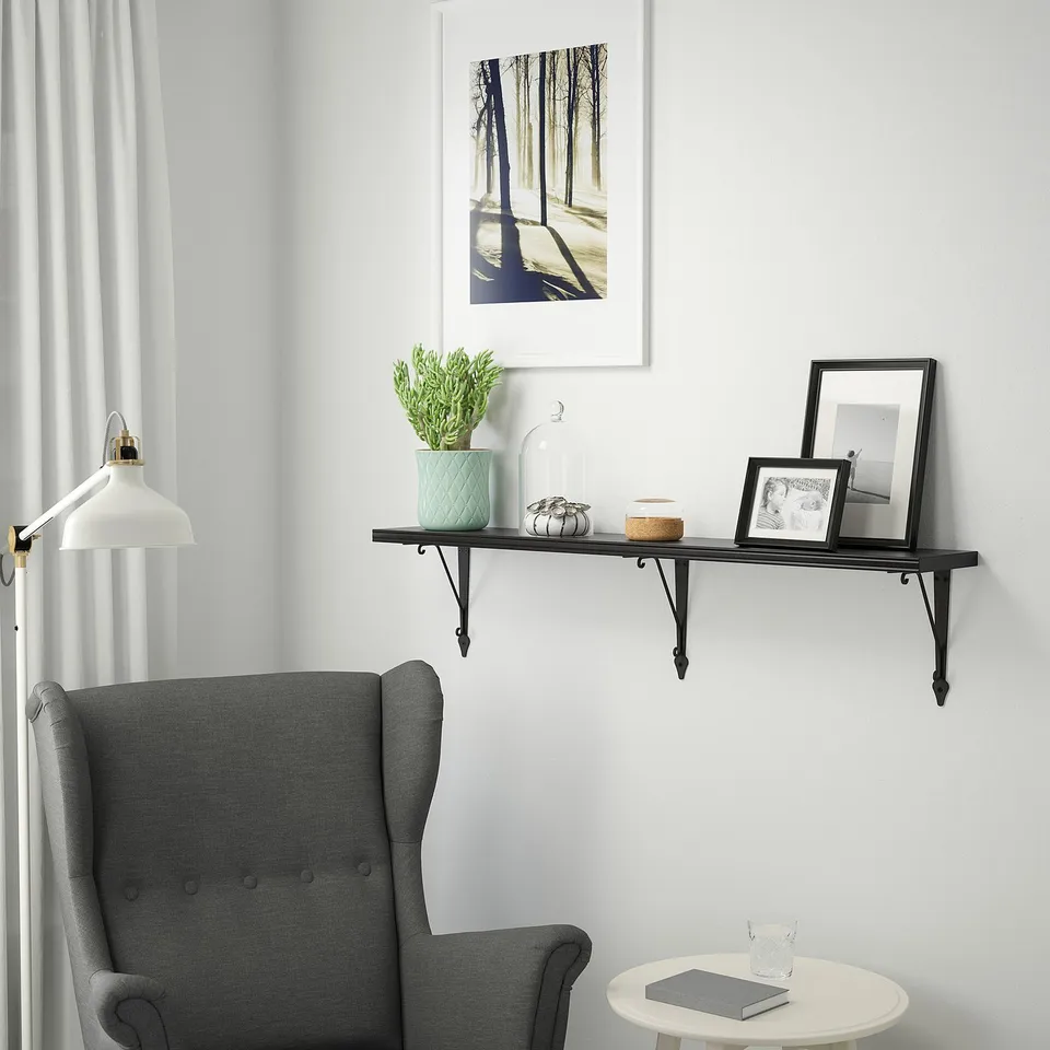 Modern living room with BERGSHULT shelf and grey armchair.