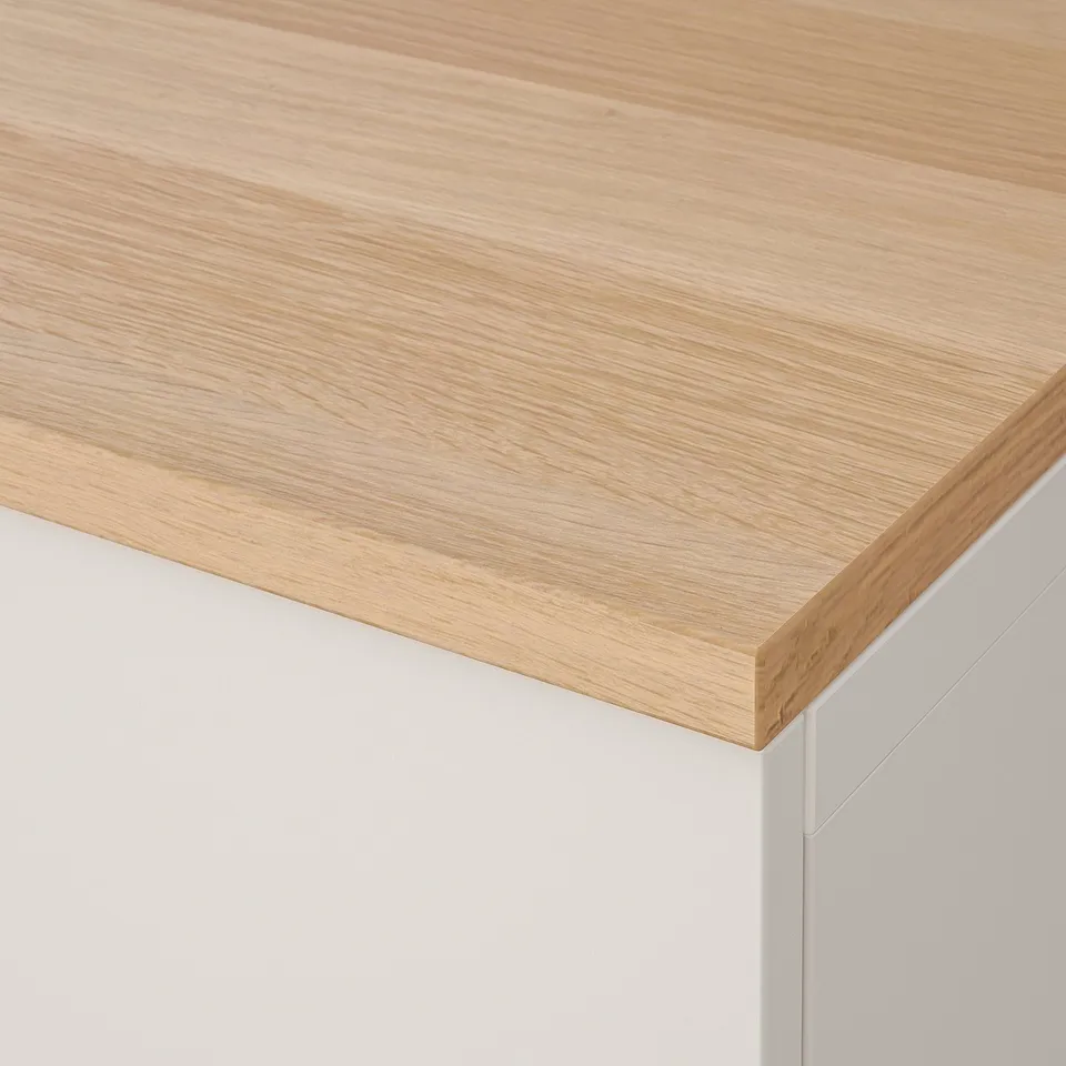 Sleek wooden countertop, smooth grain texture, crisp white cabinet edge.