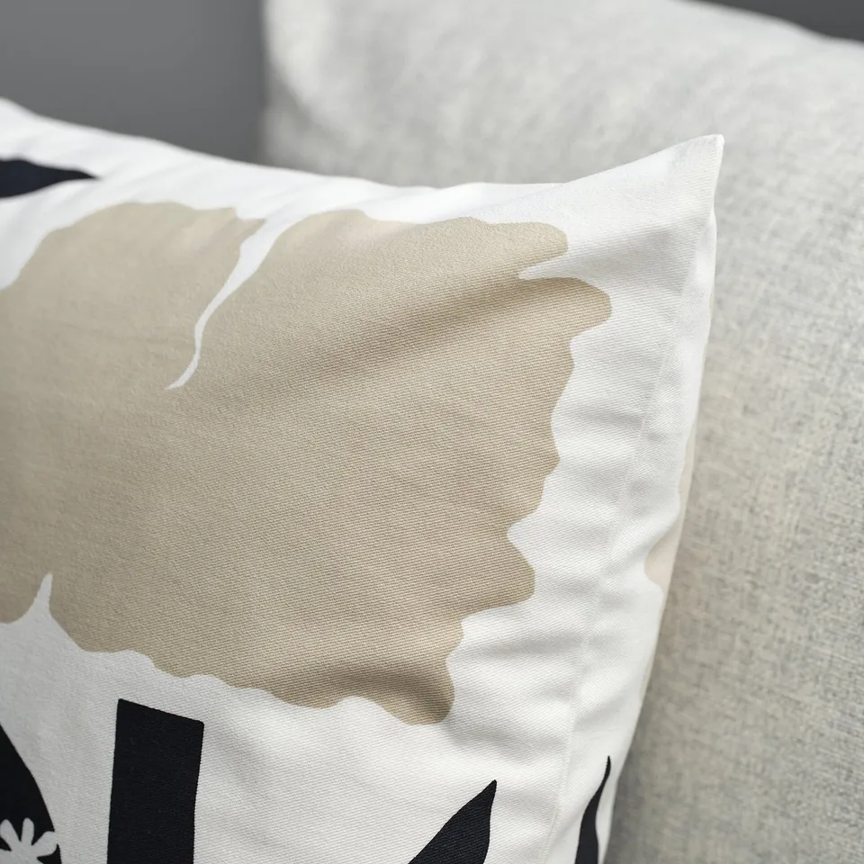 Pillowcase with gold, abstract floral print; textured cotton, visible stitching.