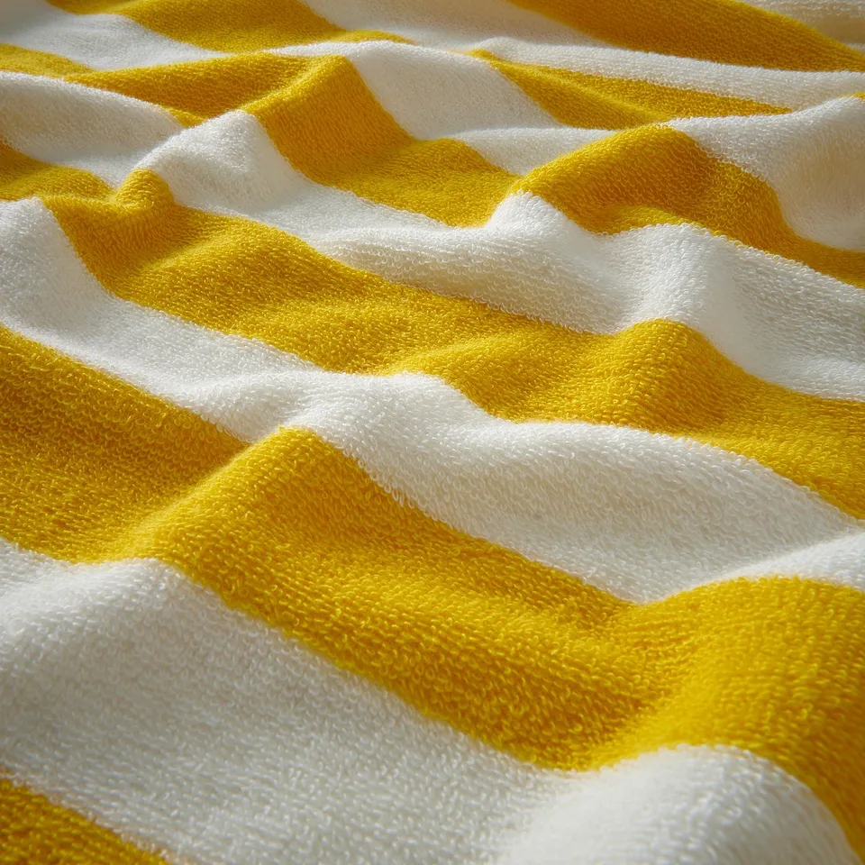 Bright yellow and white striped towel, soft and absorbent, made of 100% cotton.