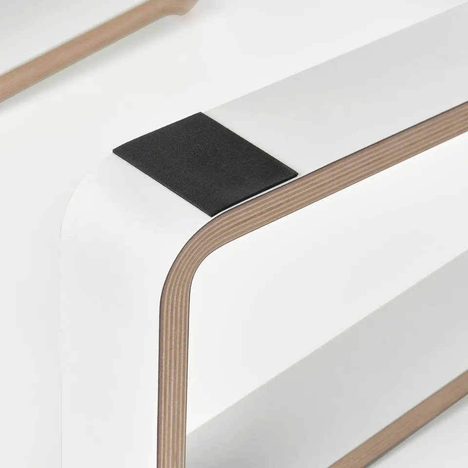 Laptop stand close-up showing sturdy, layered wood and protective pad detail.