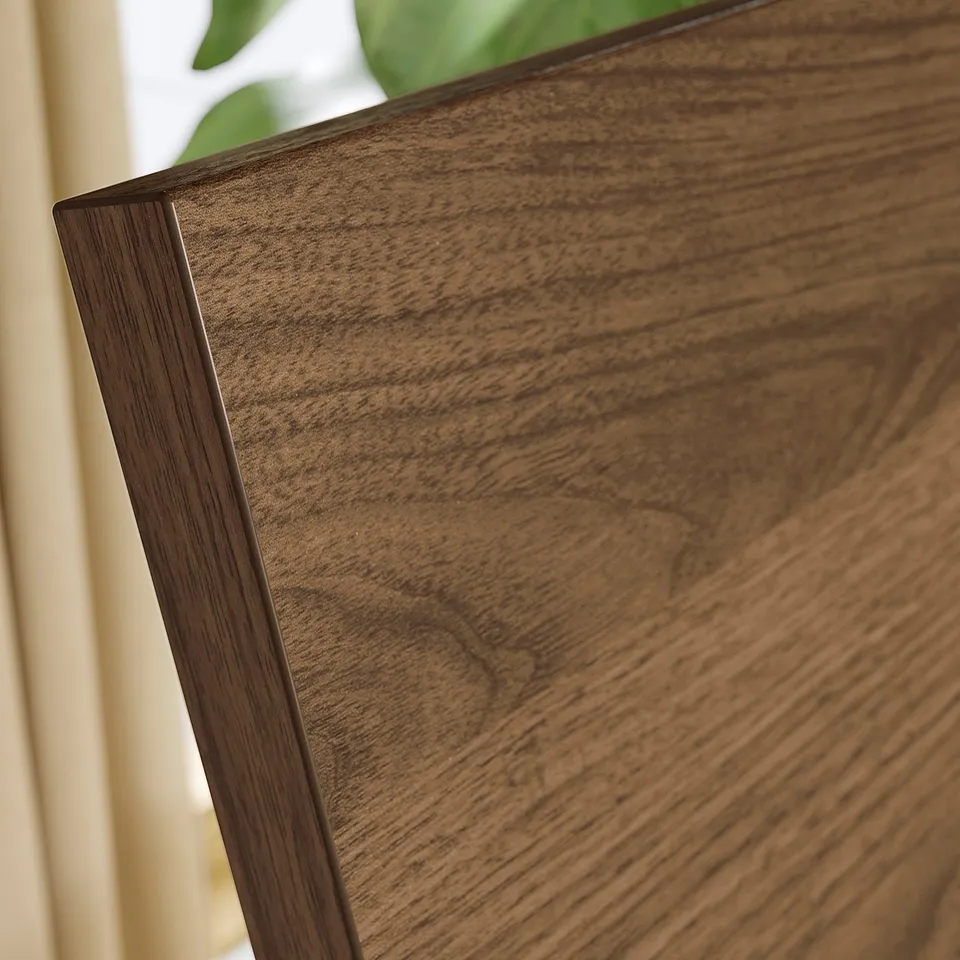 Close-up of walnut-finished wooden furniture, showcasing smooth grain texture and quality craftsmanship.