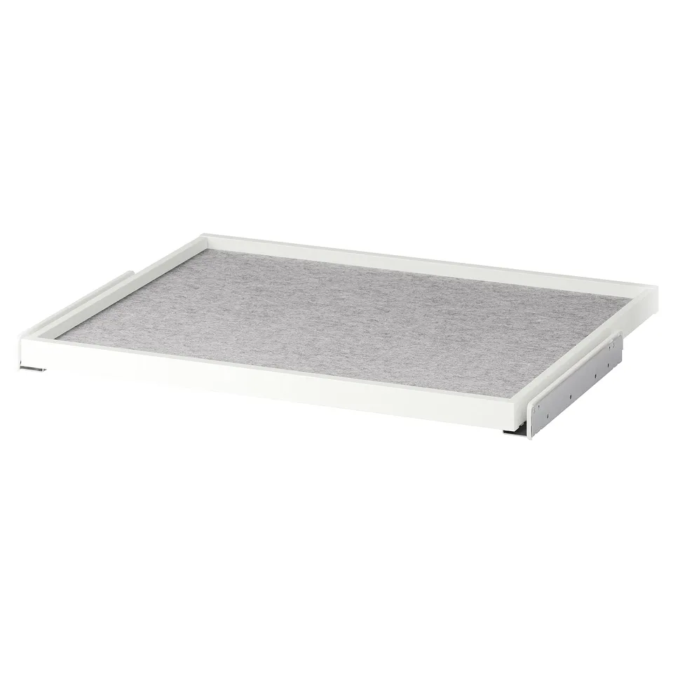 A white KOMPLEMENT pull-out tray with a grey drawer mat, designed for organising wardrobes. It has a rectangular shape with rounded edges.