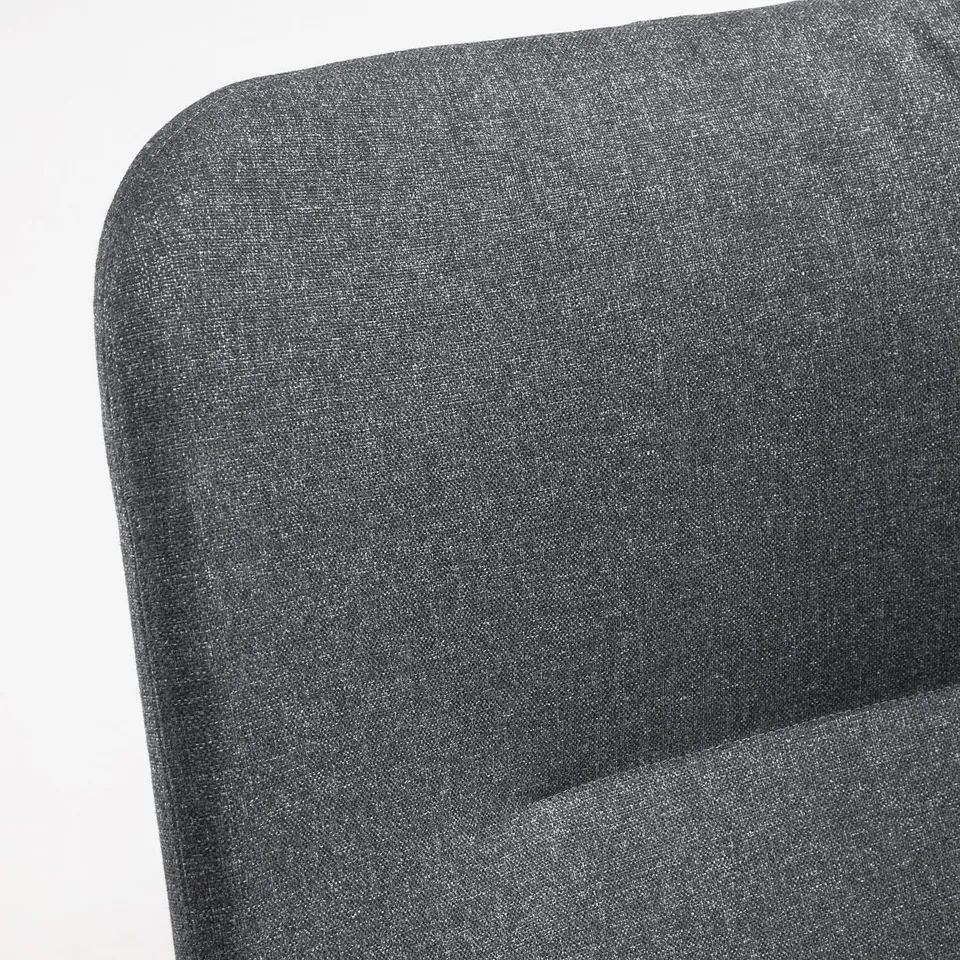 Close-up of a dark grey, cushioned chair with sleek lines and a supportive backrest.