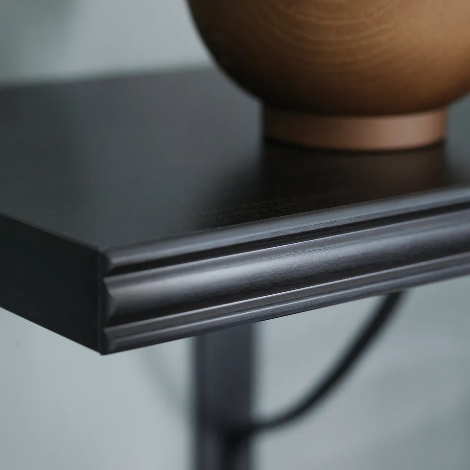 Brown-black wall shelf, one bevelled edge, smooth side, stylish modern minimalist design.