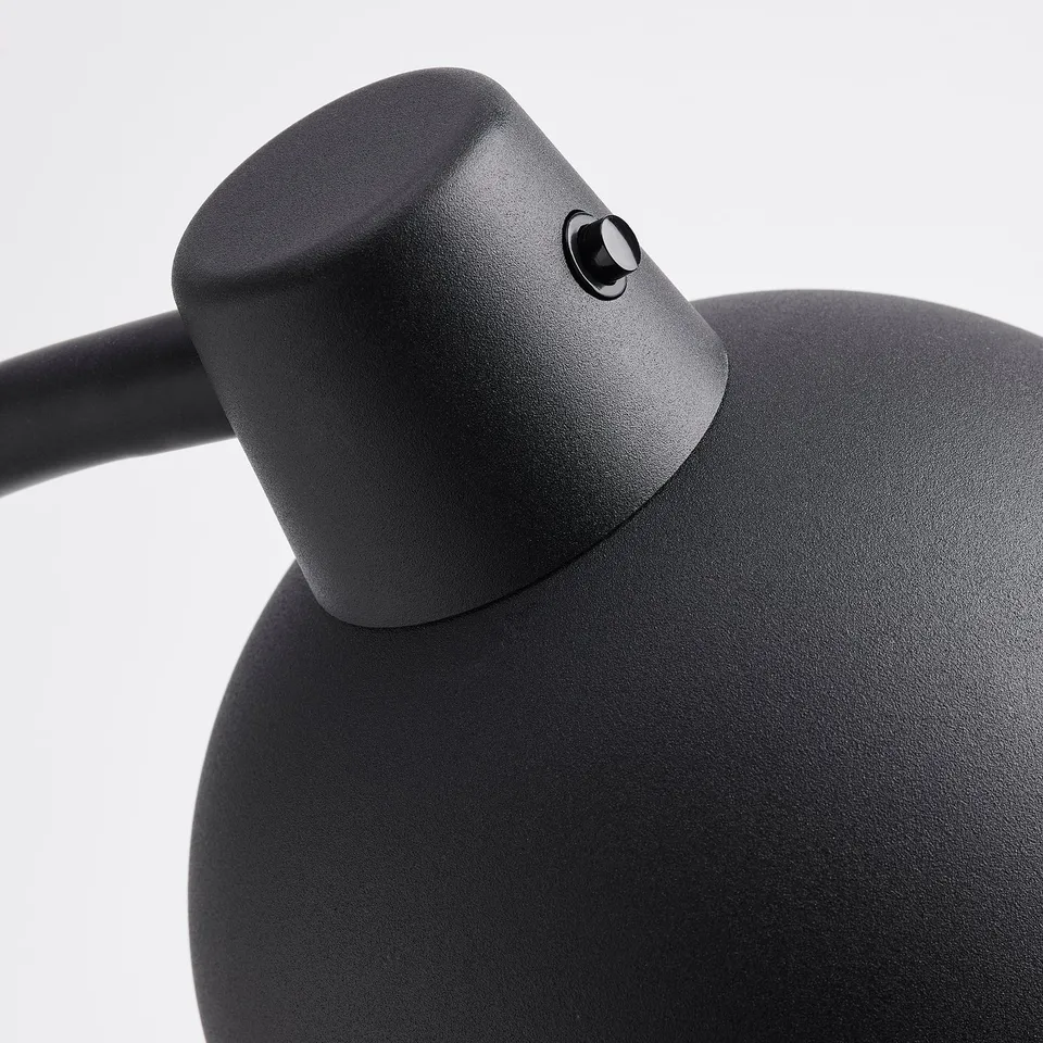 Black modern desk lamp with adjustable neck. Textured surface, sleek design, and sturdy build.