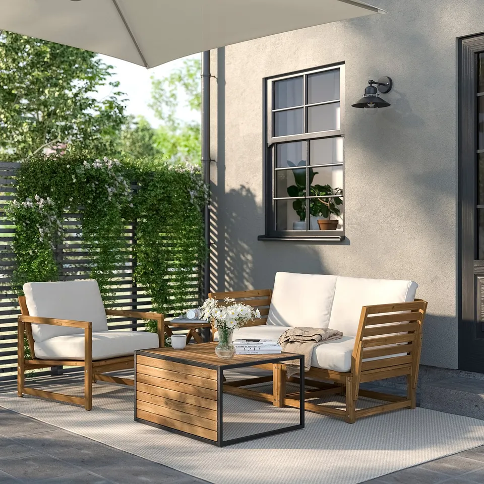 Modern outdoor setup: HÅKANSKÄR table, wooden & metal mix, versatile size, flanked by cushioned chairs.