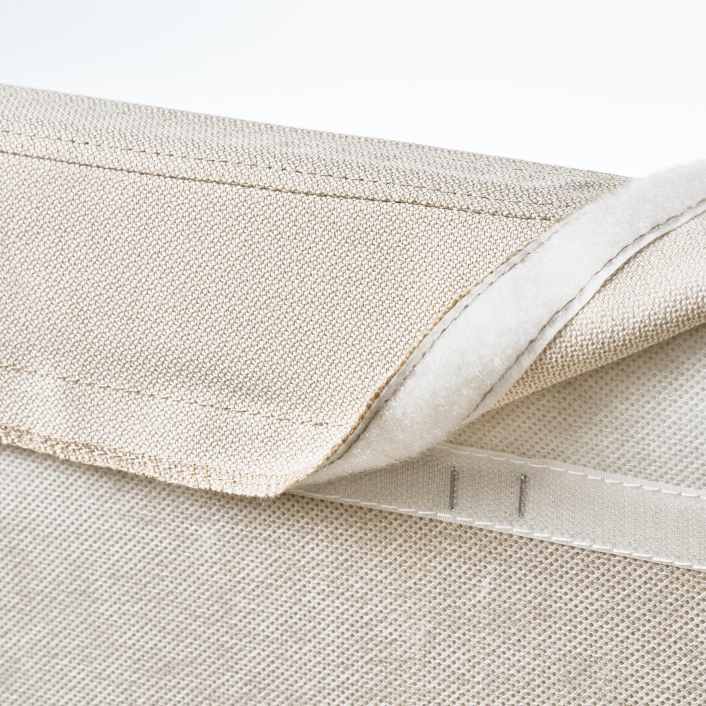 Close-up of bed frames removable, washable cover with zip detail.