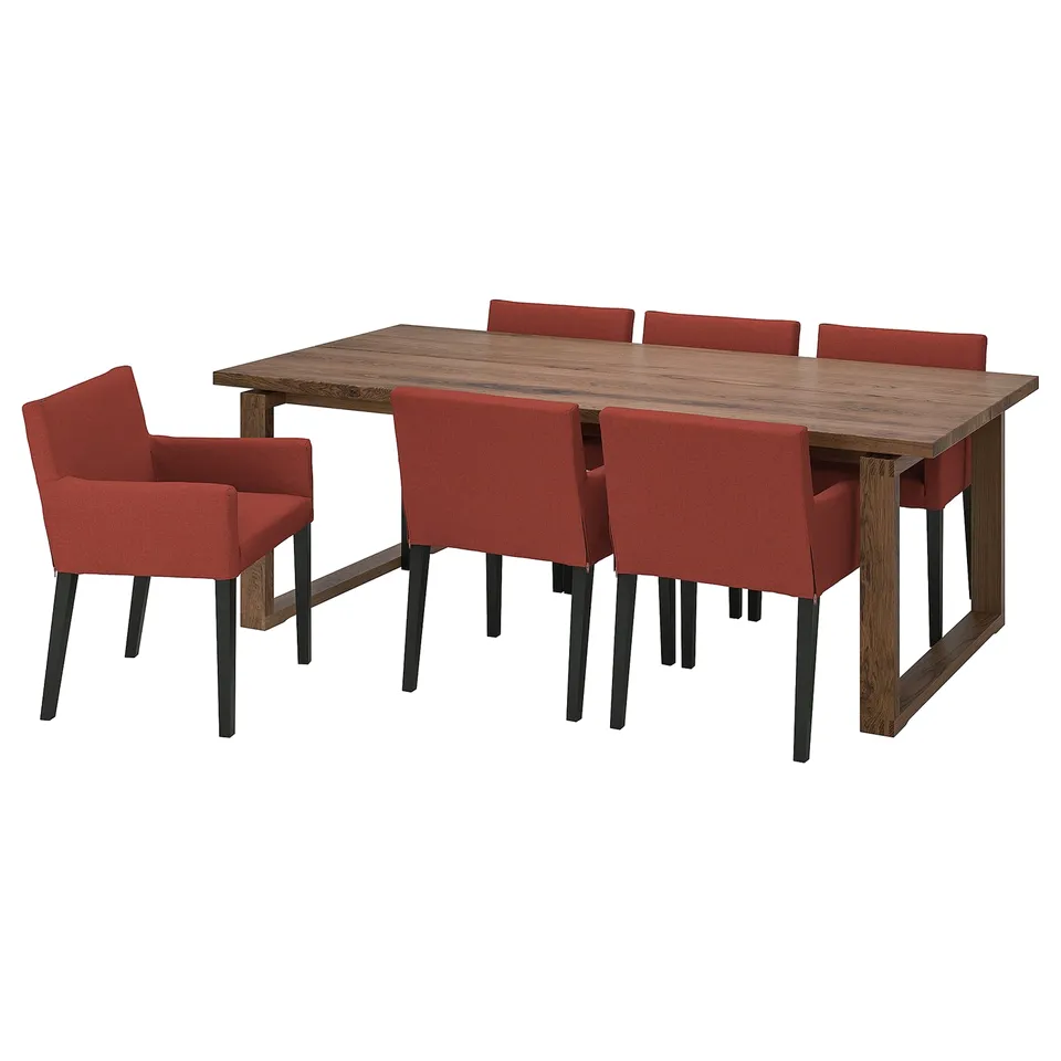 A MÖRBYLÅNGA dining set with a brown table and orange chairs, offering comfort and modern style for up to 6 people.