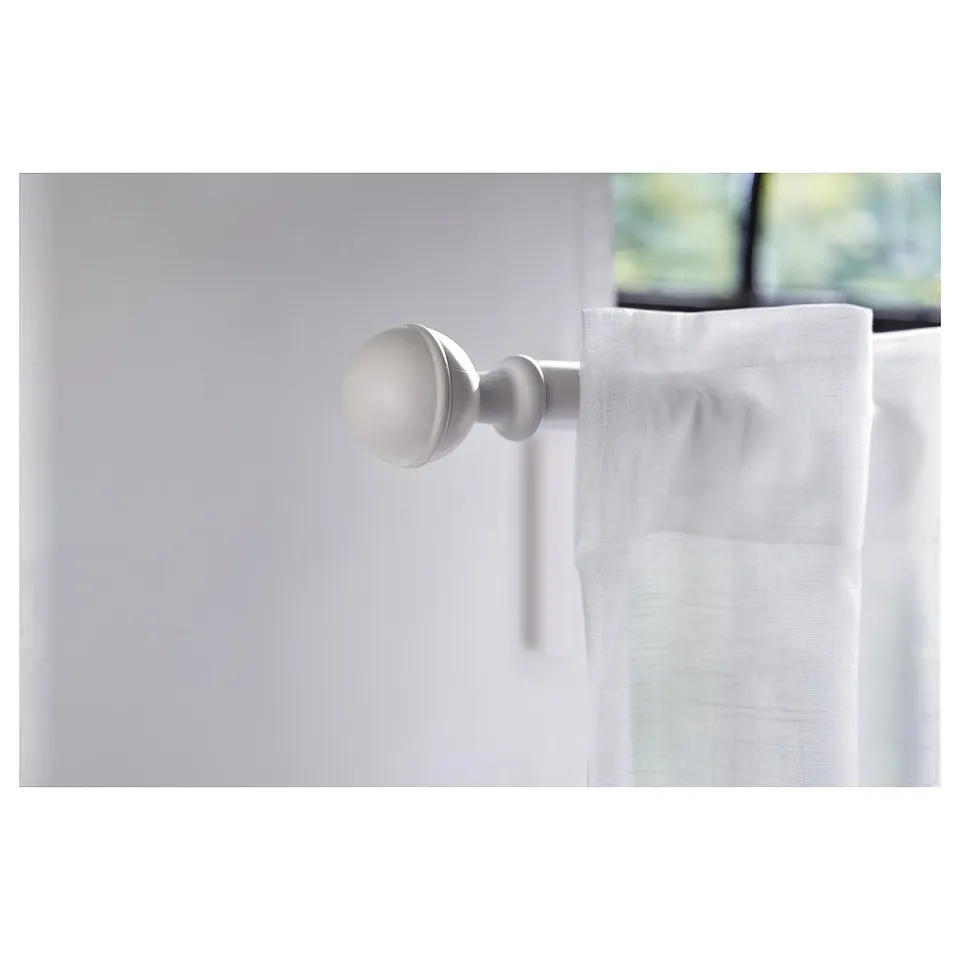 White spherical ALVARSTÅNDS finial on curtain rod.