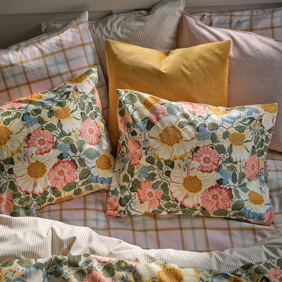 Cosy bed with soft floral pillows, mix of cute patterns, in luxurious sateen weave.