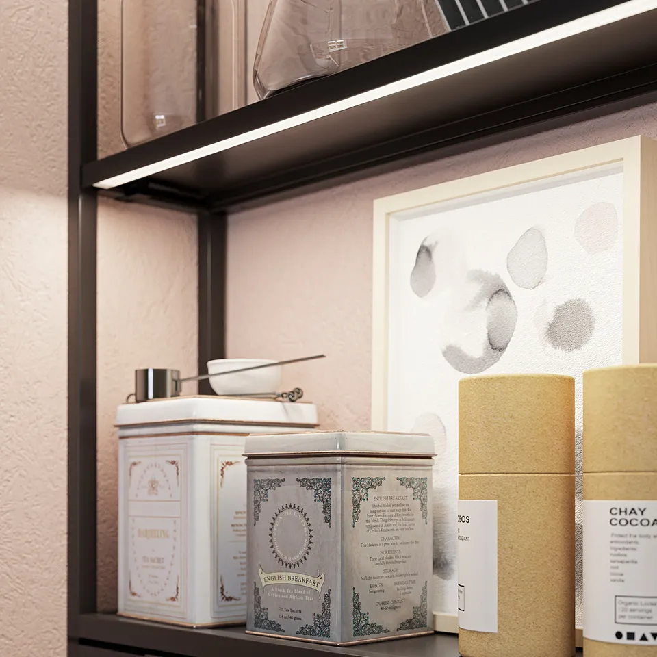 Modern kitchen shelf with led lights, displaying teas and art, including white and beige tins, glass jars, and abstract artwork.