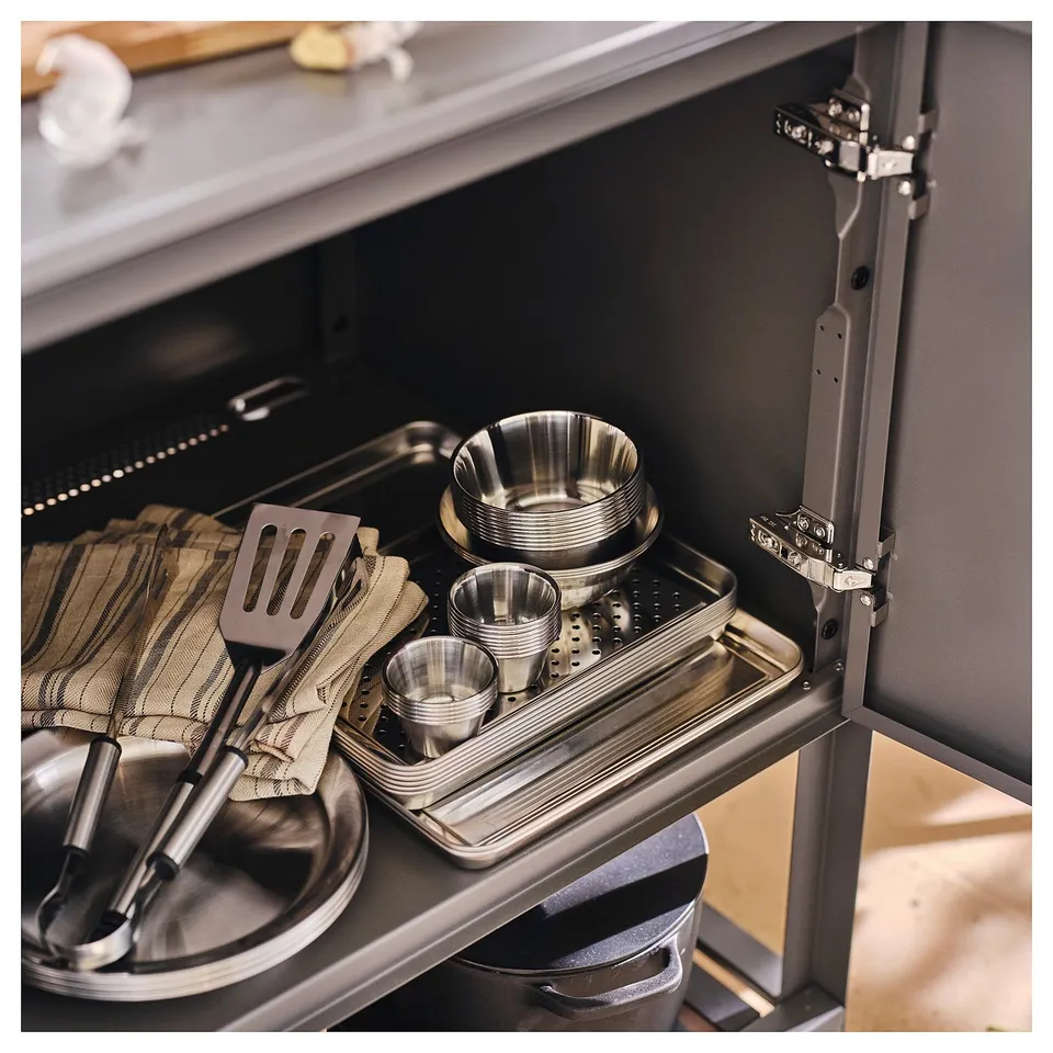 Small GRILLTIDER bowl, stainless steel, fits neatly among larger items.