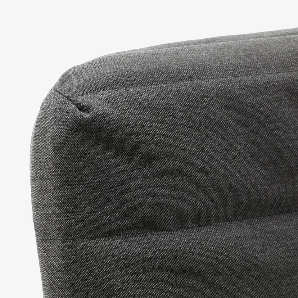 Close-up of grey fabric sofa, smooth texture, clean lines, modern design.