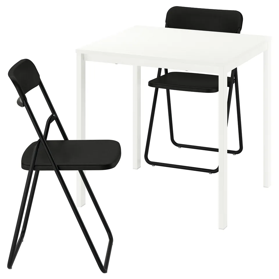 A compact dining set. It a white square table and two black foldable chairs. The chairs have black seats and backs with metal frames.