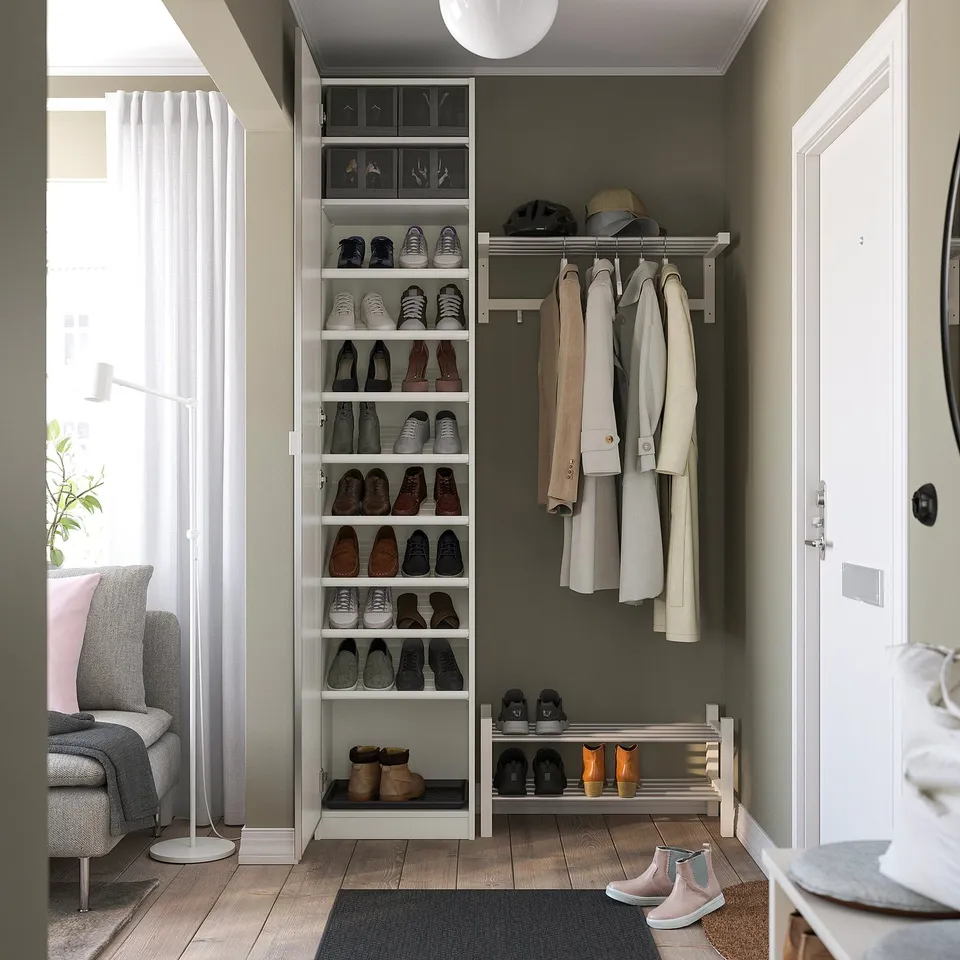 Neatly organised entryway with shoe rack and coat hanger, maximising space.