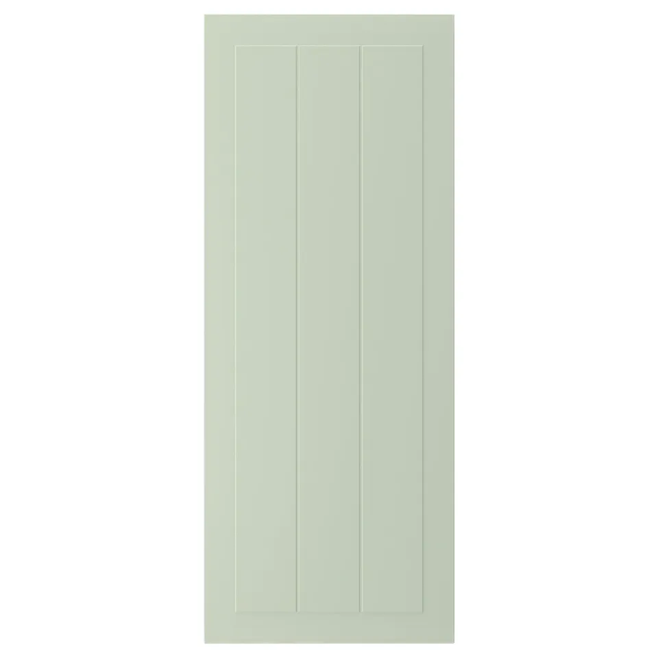 A green STENSUND cabinet door with a grooved panel design, made from fibreboard with a smooth, easy-to-clean finish.