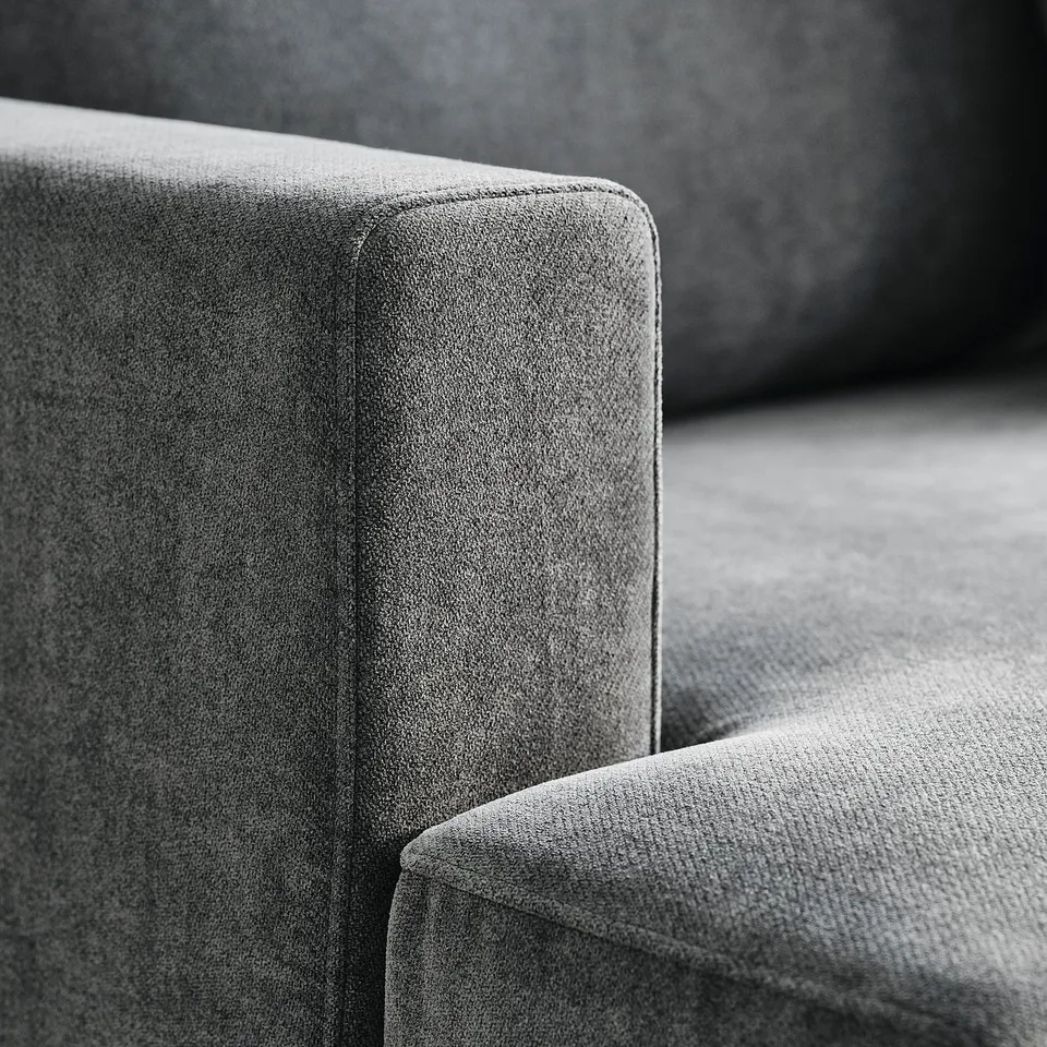 Close-up of stylish, high-quality sofa; plush cushions, clean lines, durable texture.