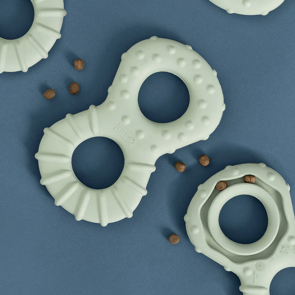 Dog toys of natural rubber with carved holes and textured surfaces for hiding treats, promoting activity and bonding.
