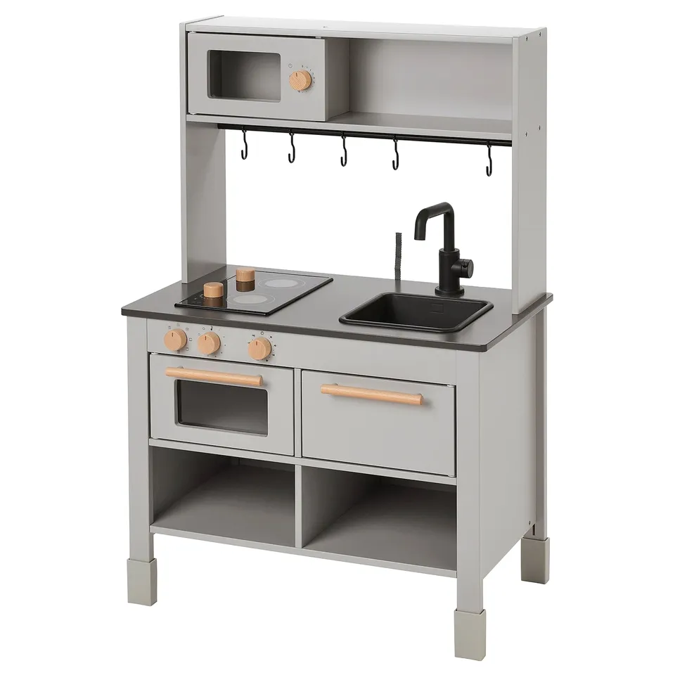 SILLTRUT kids kitchen with grey body, wooden knobs, mechanical stovetop, sink, oven, and hooks.