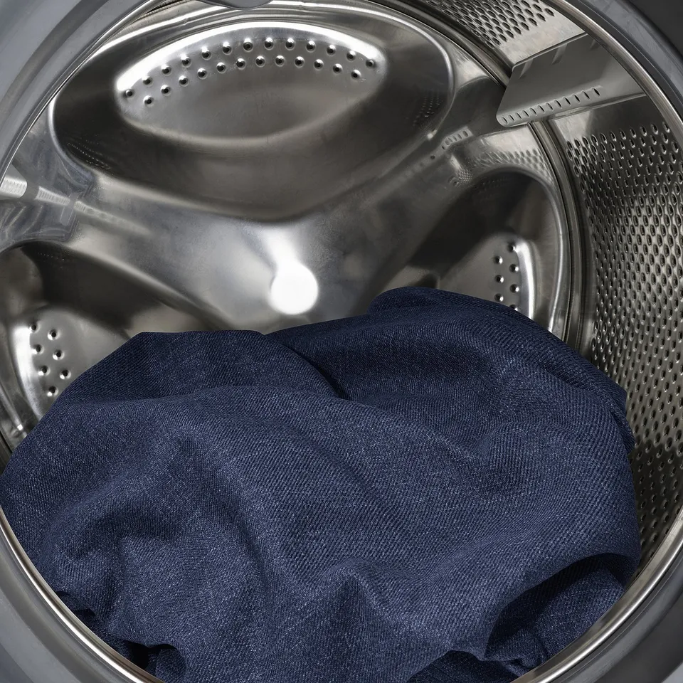 Washing machine with dark clothes. Easy-to-clean, removable interior.