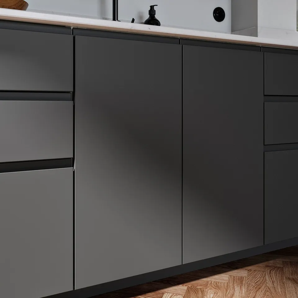 Modern kitchen cabinets with matte dark grey VOXTORP fronts, smooth surfaces, and integrated handles, featuring clean lines and a minimalist design.