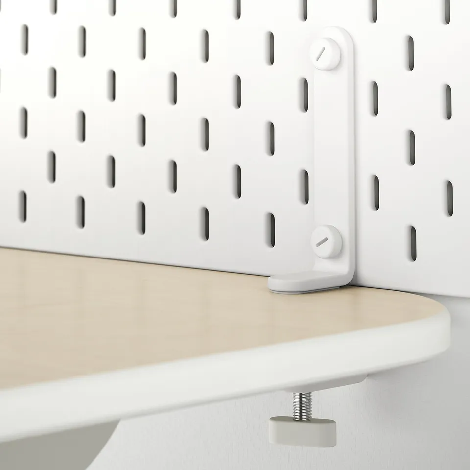 White SKÅDIS pegboard shelf with adjustable hooks for versatile organisation. Perfect for small items, customizable, no tools needed.