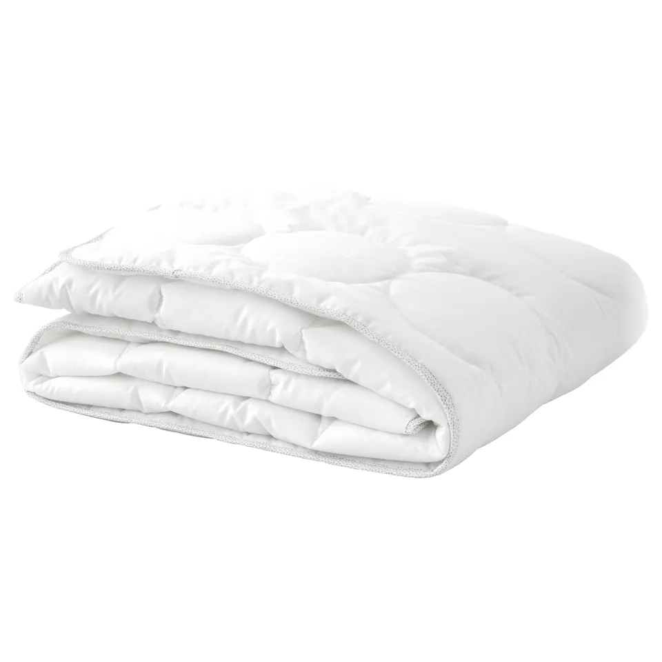 A folded white LENAST baby duvet. Its rectangular, with a soft, quilted design, made of cotton and lyocell for breathability.