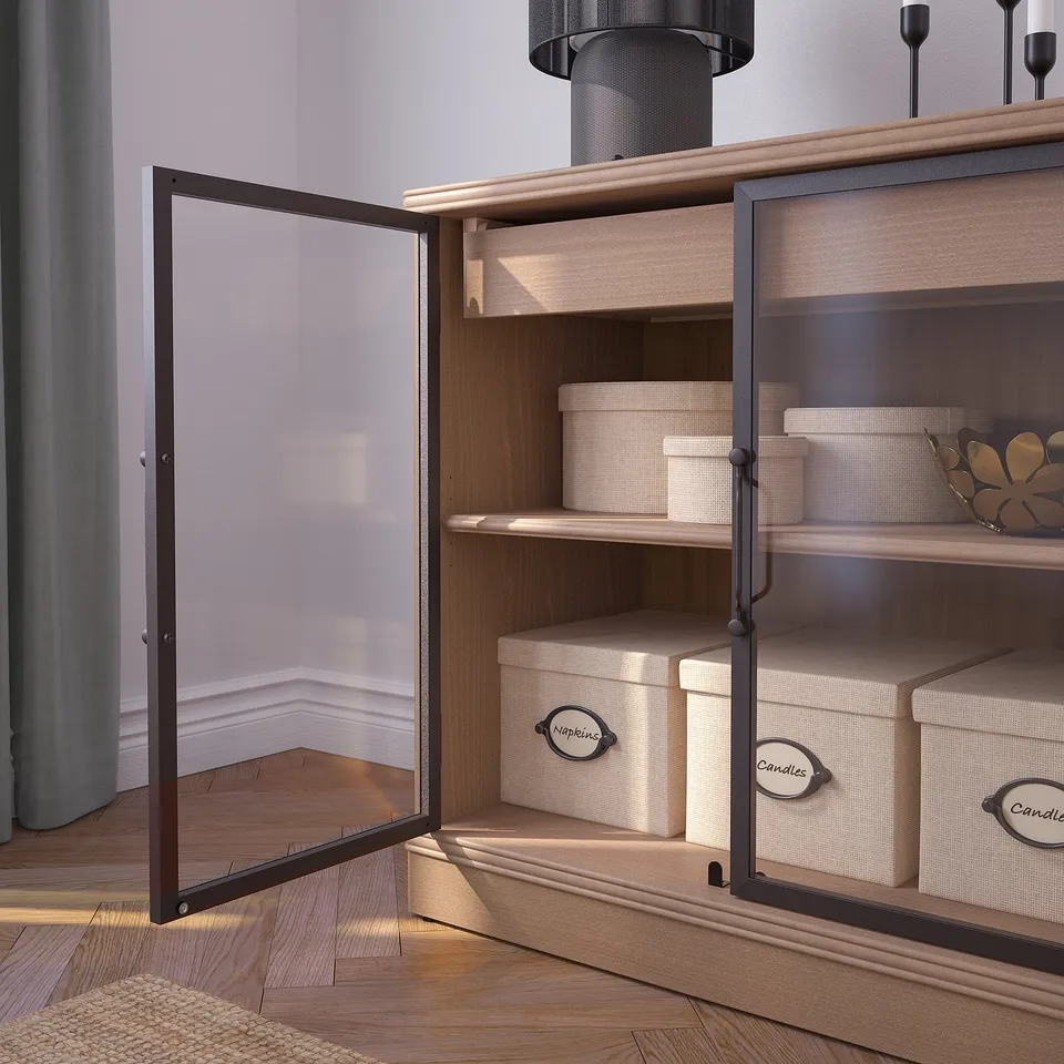 Open wooden cabinet with glass doors displays neatly organised boxes, indicating storage and organisation functions.
