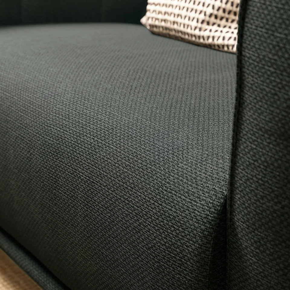 Close-up of dark VISKAFORS armchair, textured fabric, curved edges.