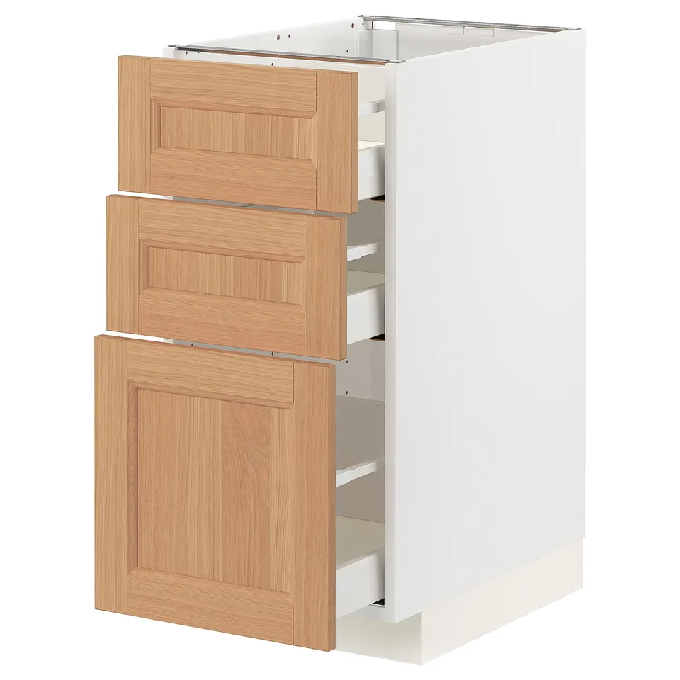 White METOD kitchen cabinet with oak drawers, two open.