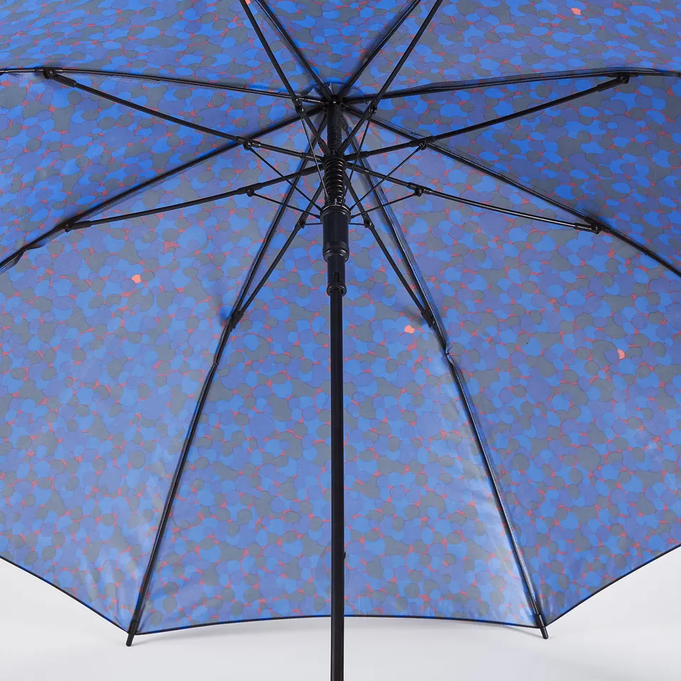 Open umbrella with blue, grey, and red pattern; sturdy black frame, recycled fabric.