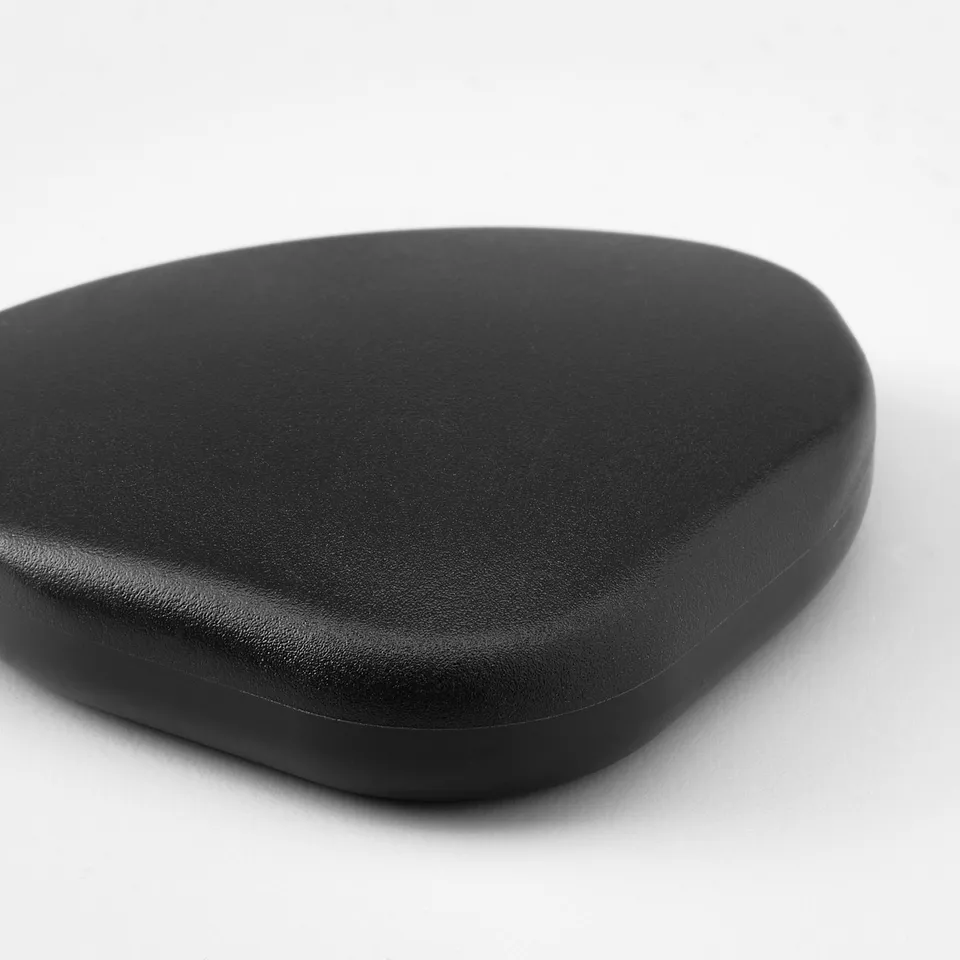 Dark, smooth, oval-shaped object, likely an anti-collision bumper, displayed on a plain white surface. Matte finish, evenly rounded edges.