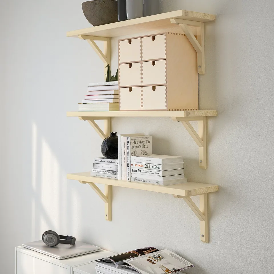Wooden wall shelf displays books, boxes, and decor; maximises wall space, available in multiple sizes.