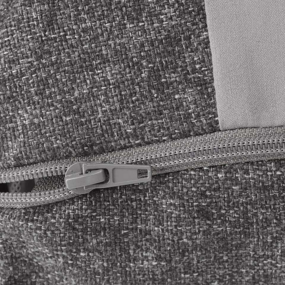 Close-up of robust zip on soft, textured grey fabric, showcasing quality stitching.
