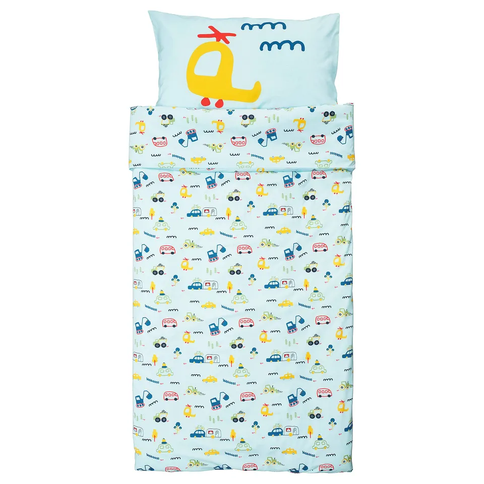 Childs light blue bedding set with colourful vehicles, planes, and trains print, made of 100% cotton.