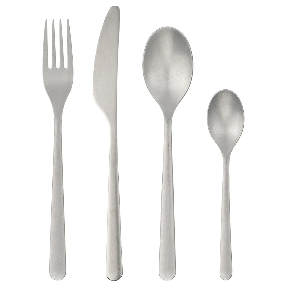 PRAKTBOTIA silver cutlery set: fork, knife, two spoons. Rustic matte finish, stainless steel, elegant design.