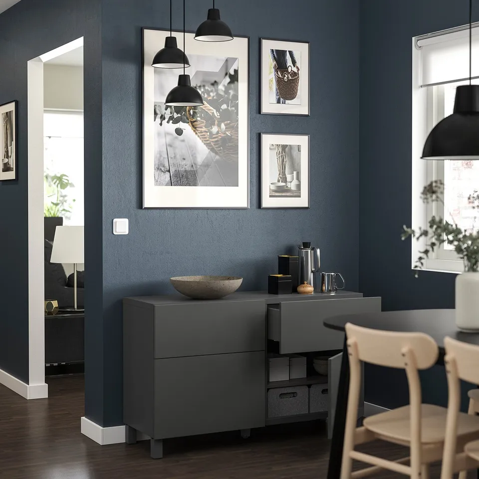 Modern grey dining area with BESTÅ storage unit, chairs, pendant lamps, and wall art.