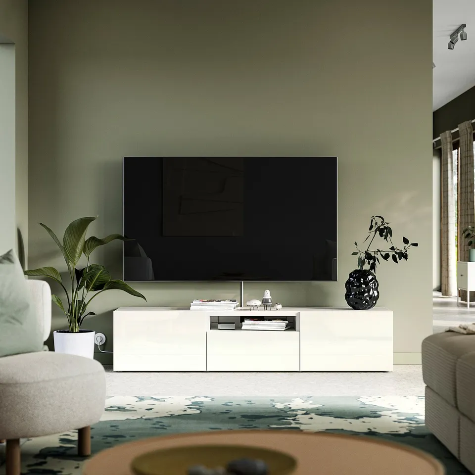 Modern living room with BESTÅ tv bench, tv, plants, sofa, rug, window.